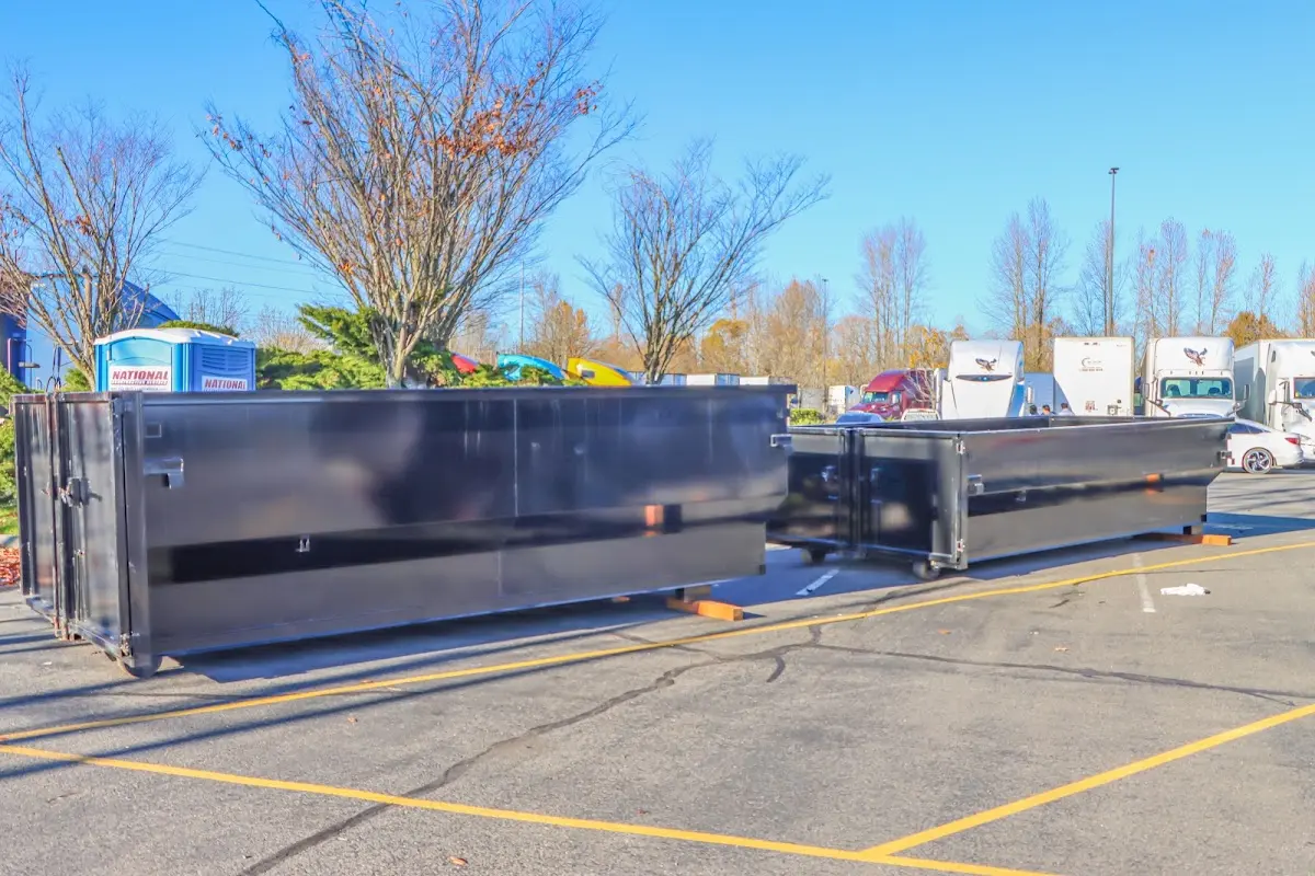 Professional dumpster rental service with roll-off container on residential driveway in Mecca